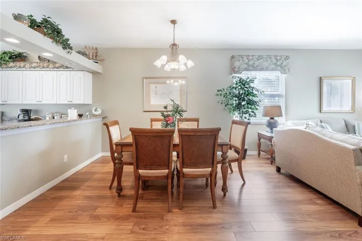 Dining space featuring hardwood / wood-style floors and an inviting chandelier