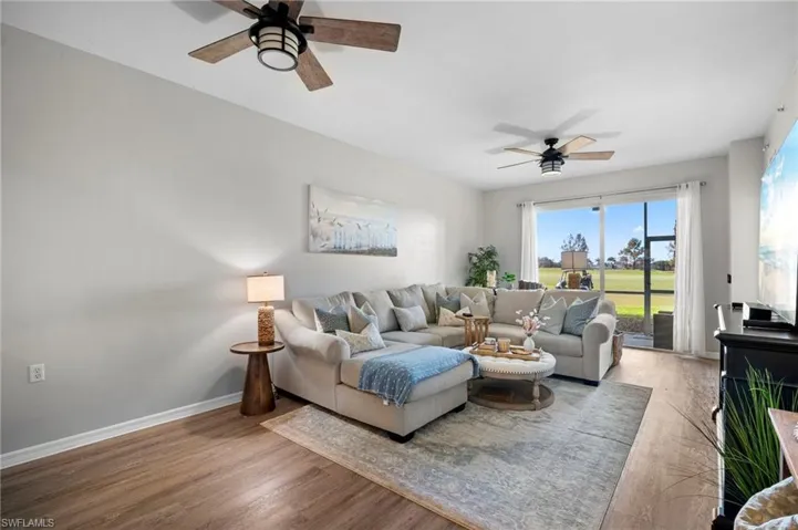 Living room featuring wood finished floors and ceiling fan