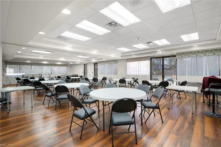 Dining area with a tray ceiling and dark wood finished floors