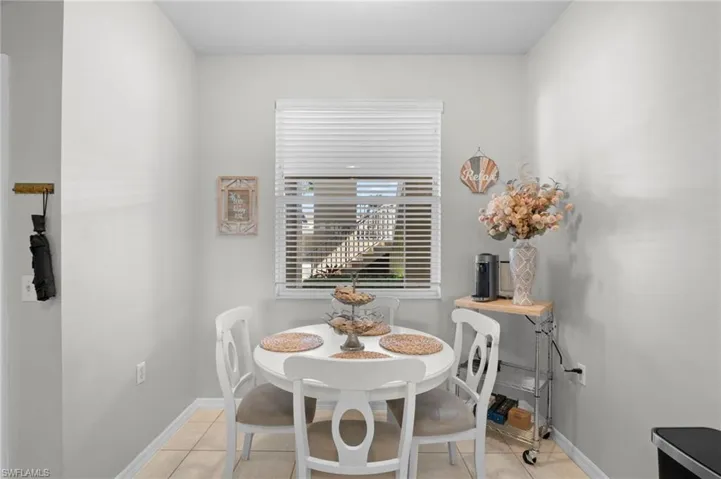Dining room with light tile patterned flooring and baseboards