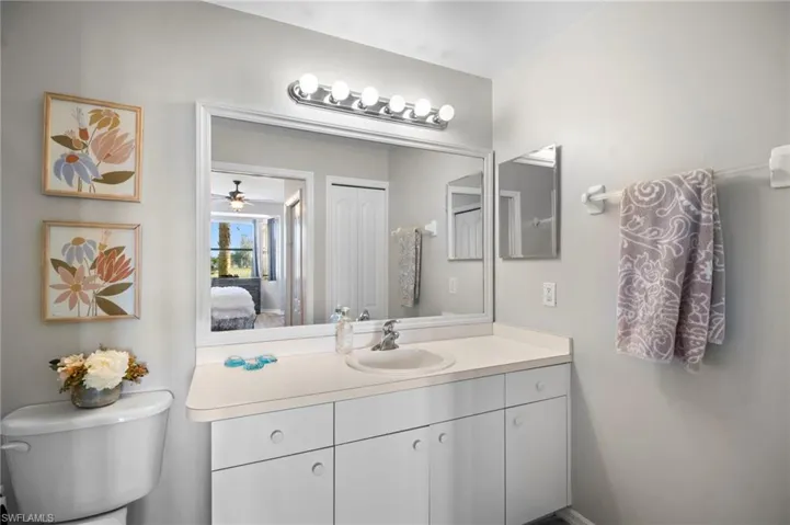 Bathroom with vanity, connected bathroom, and a ceiling fan