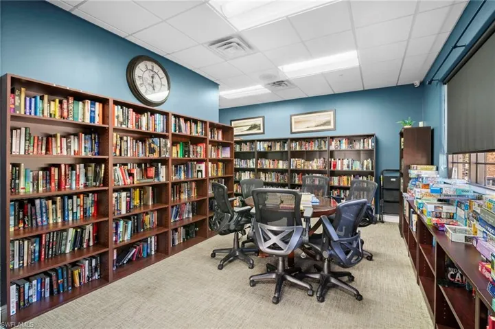 Office featuring bookshelves and a drop ceiling
