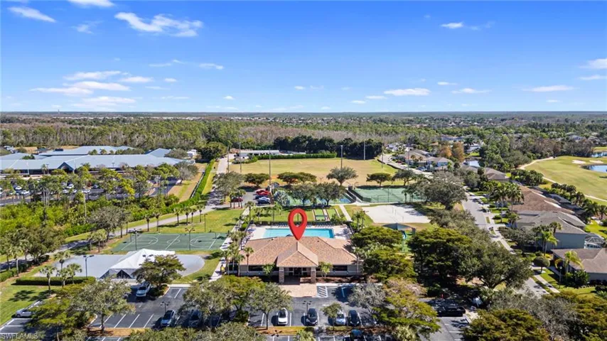Aerial view of property's location with nearby suburban area and a large body of water