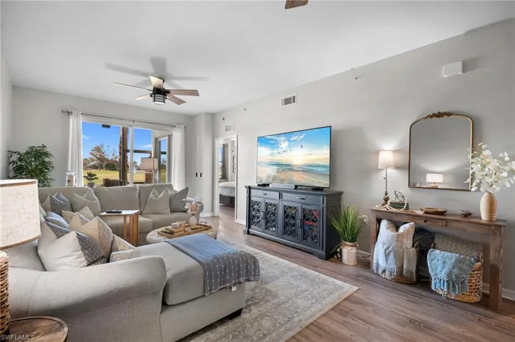 Living room with a ceiling fan and wood finished floors