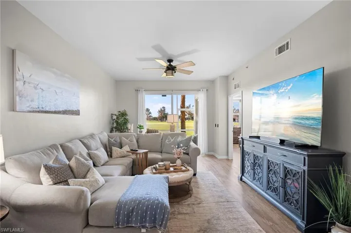 Living area featuring wood finished floors and a ceiling fan