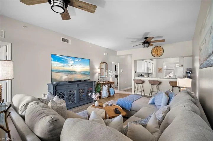 Living room with ceiling fan and wood finished floors