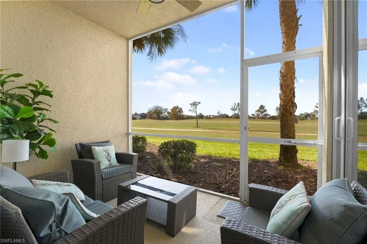 Sunroom / solarium with an outdoor hangout area, view of golf course, and a ceiling fan