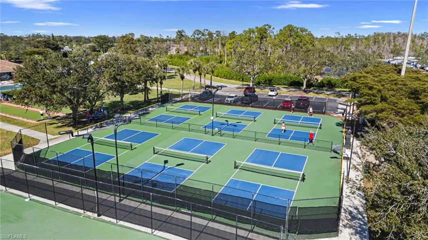 View of tennis court featuring view of scattered trees