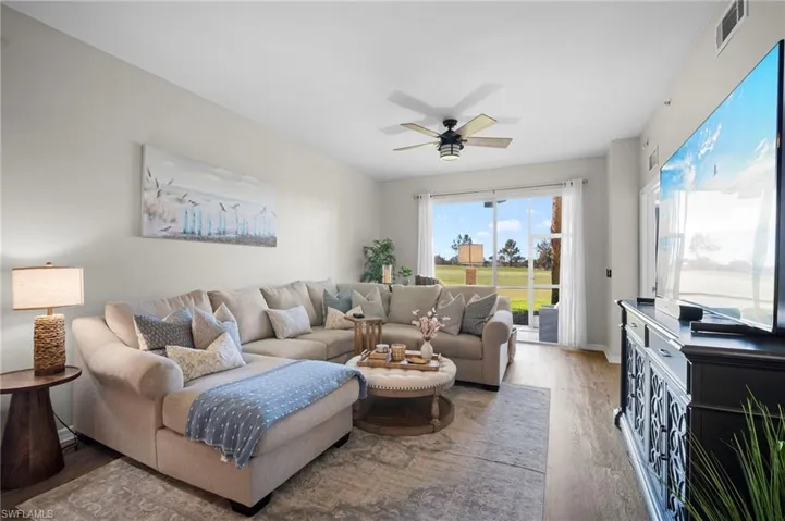 Living room featuring wood finished floors and a ceiling fan