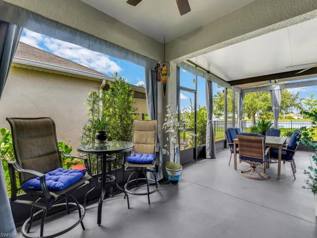 Sunroom / solarium featuring outdoor dining space, a textured wall, ceiling fan, and finished concrete flooring