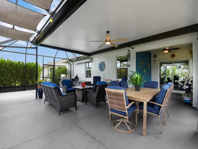 View of patio / terrace with outdoor lounge area, a sunroom, outdoor dining space, and a ceiling fan