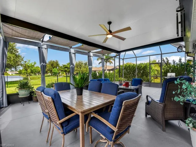 Sunroom featuring a ceiling fan, a patio, outdoor dining area, and outdoor lounge area