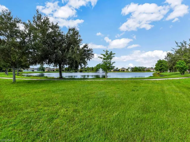 View of home's community with a lawn and a water view