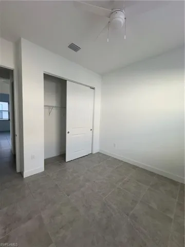 Unfurnished bedroom featuring a closet and ceiling fan
