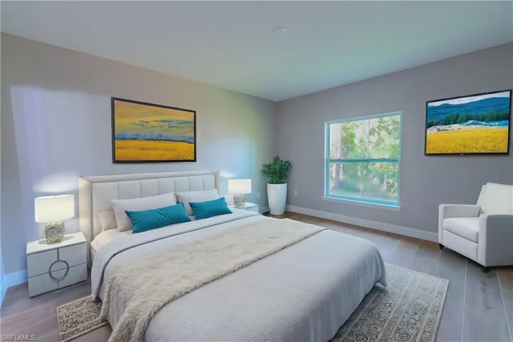 Bedroom with wood finished floors and baseboards