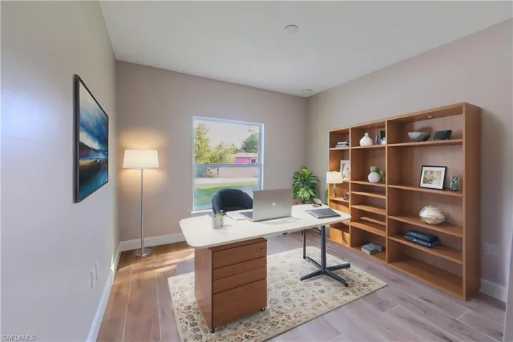 Office space with light wood-style floors and baseboards