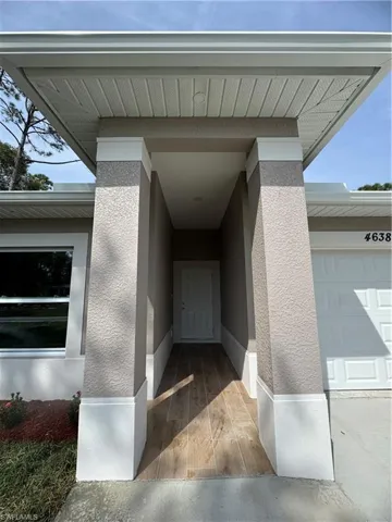 Doorway to property with stucco siding