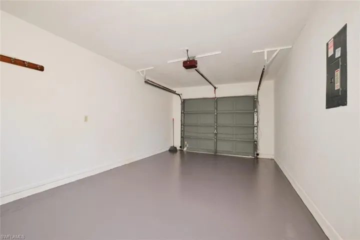 Garage with a garage door opener and electric panel