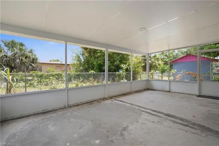 Screened outdoor patio featuring a concrete floor, white aluminum framing, and a solid white ceiling