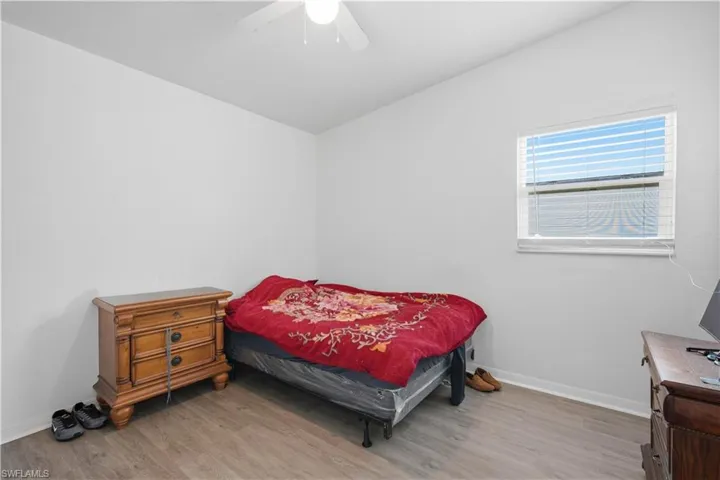 Room featuring light-toned walls and wood-finish flooring