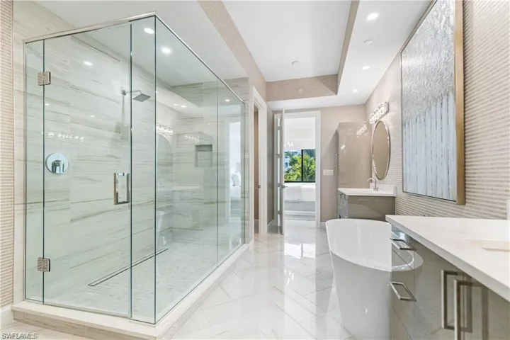 Bathroom featuring vanity and plus walk in shower
