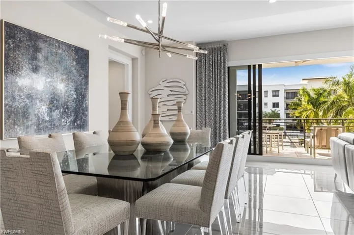 Dining space featuring tile patterned flooring and a chandelier