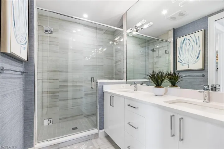 Bathroom featuring vanity and a shower with shower door
