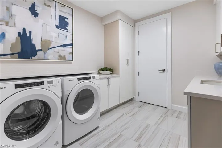 Laundry area with cabinets and separate washer and dryer