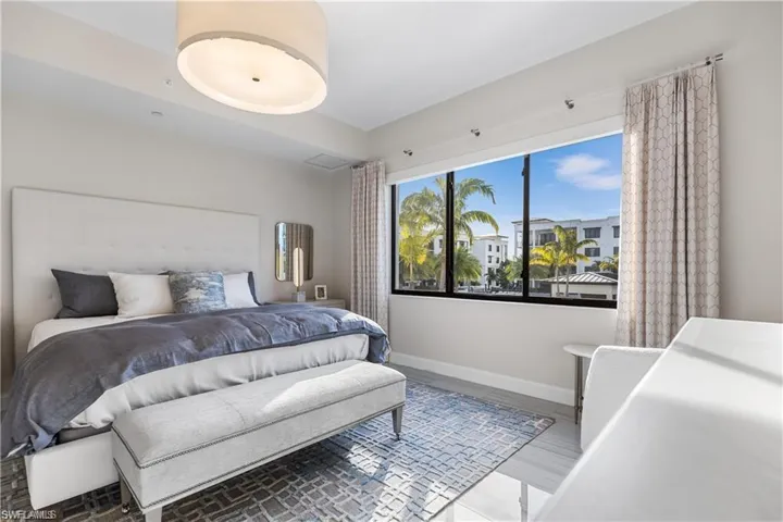Bedroom with tile flooring,automatic shades