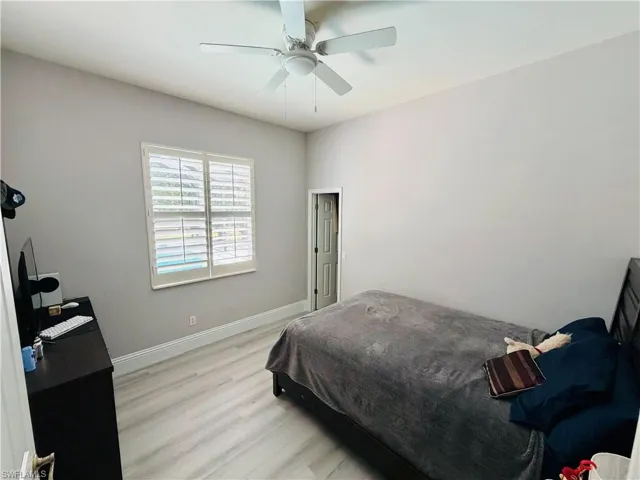 Bedroom with light wood-style flooring and a ceiling fan