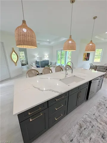 Kitchen featuring sink, pendant lighting, and plenty of natural light