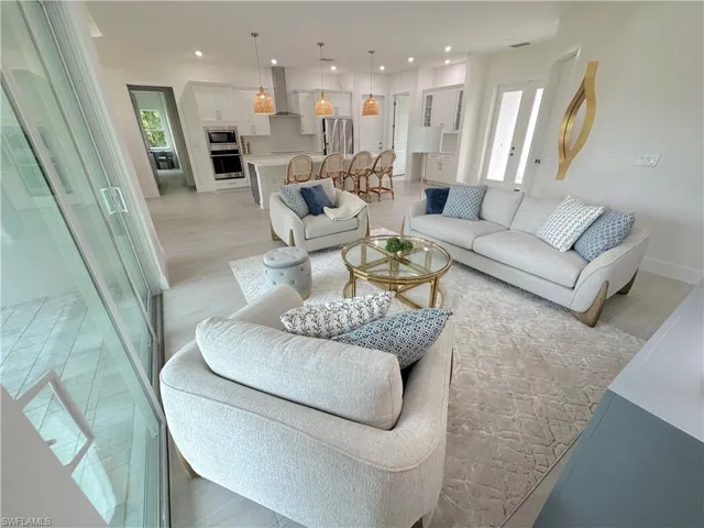 Living room featuring light wood-type flooring and a healthy amount of sunlight
