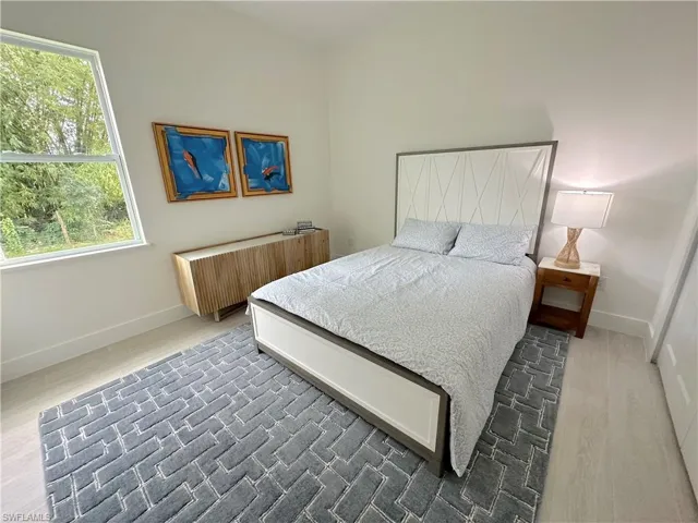 Bedroom with radiator and dark hardwood / wood-style flooring