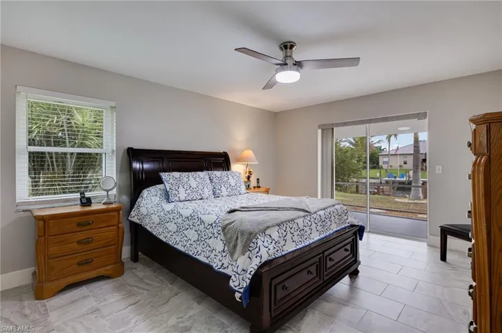 Bedroom featuring access to exterior and ceiling fan