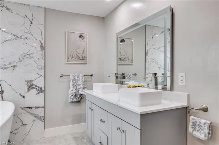 Full bath with a freestanding tub and double vanity