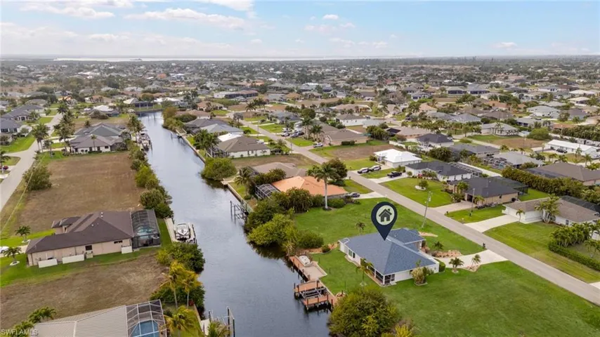 Aerial perspective of suburban area featuring a large body of water