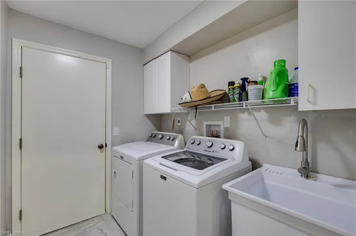 Laundry area with cabinet space and independent washer and dryer