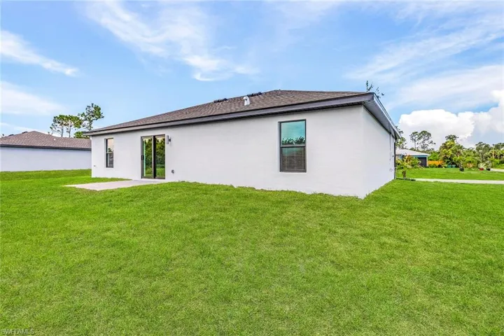 Rear view of house with a yard