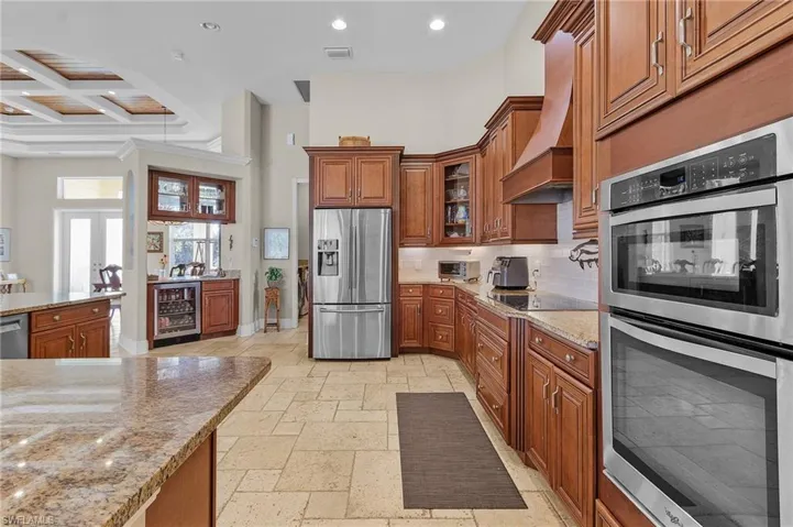 Kitchen with adjacent wet bar and beverage cooler