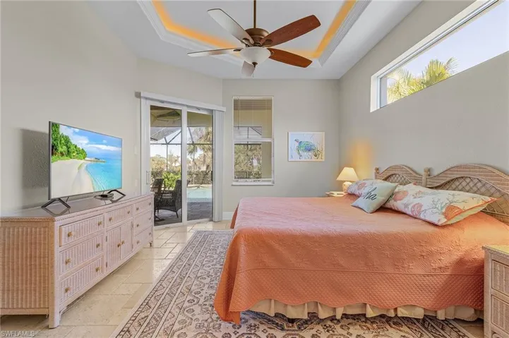 Primary Bedroom with access to pool and tray ceiling