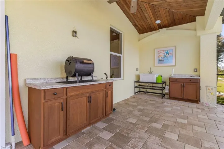 Patio with sink and custom cabinetry