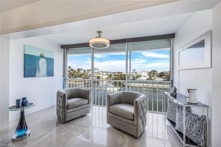 Living area with a water view and expansive windows