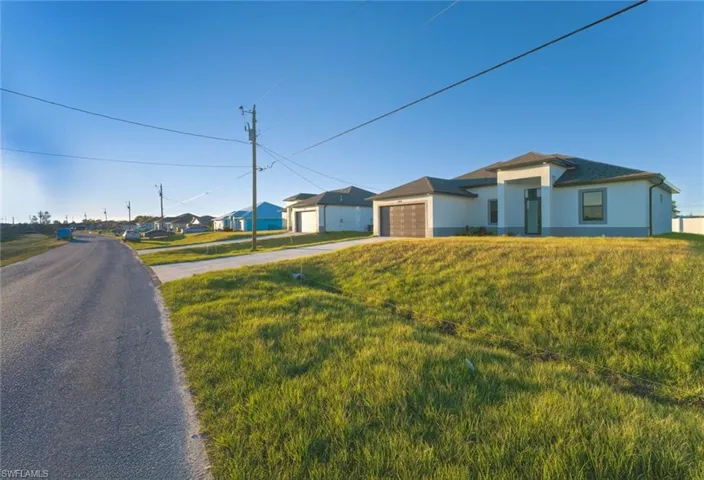 Single story home featuring a front lawn and a garage