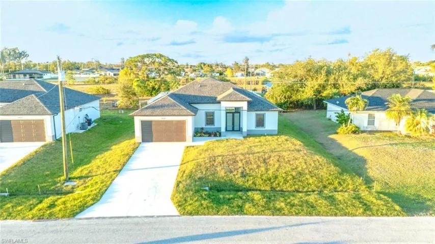 View of front of home featuring a garage and a front lawn