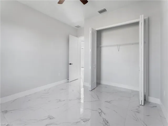 Unfurnished bedroom featuring ceiling fan and a closet