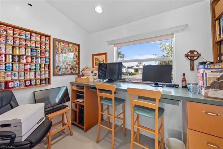 Office space with built in desk and vaulted ceiling