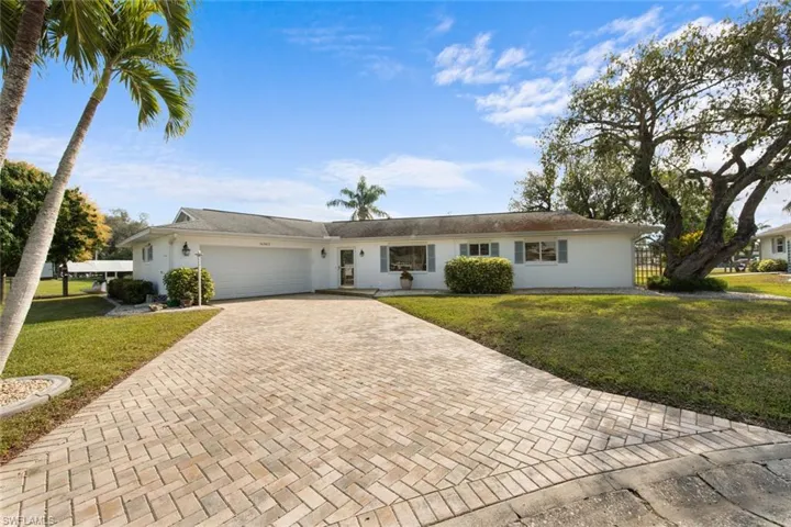 Ranch-style home with a front lawn and a garage