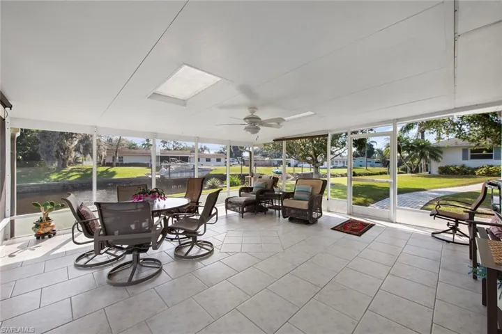 Sunroom / solarium featuring ceiling fan