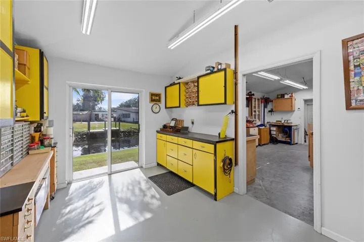 Kitchen with a water view and lofted ceiling