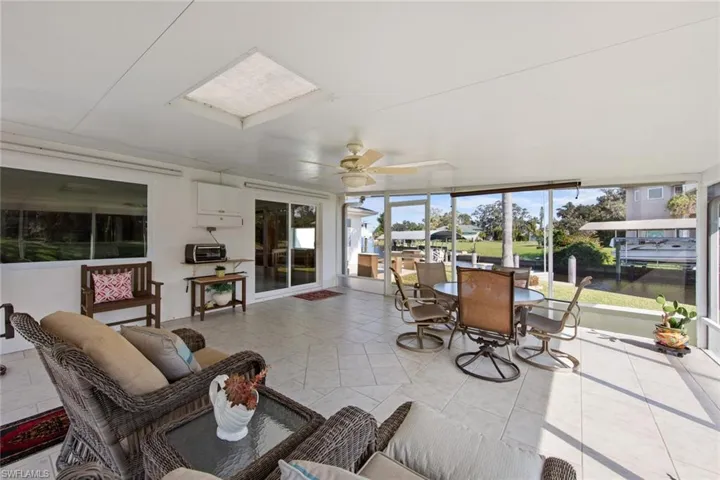 Sunroom / solarium featuring ceiling fan